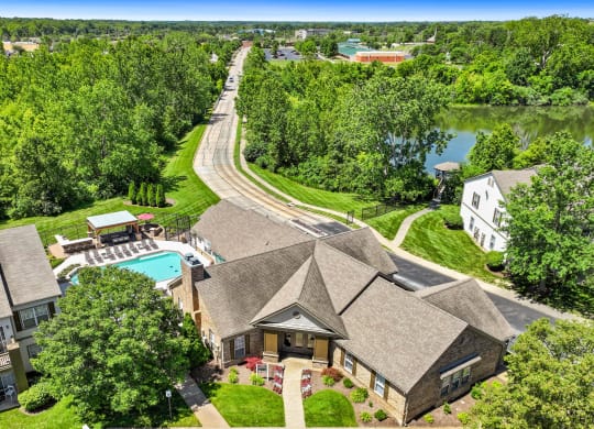 aerial view of a house with a swimming pool and a river