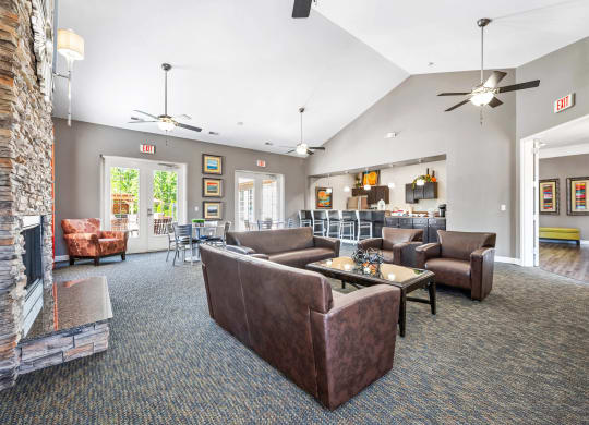 a living room with couches and chairs and a fireplace