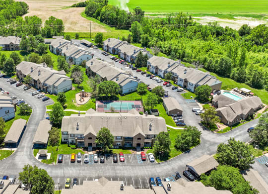 an aerial view of a neighborhood of houses with cars parked