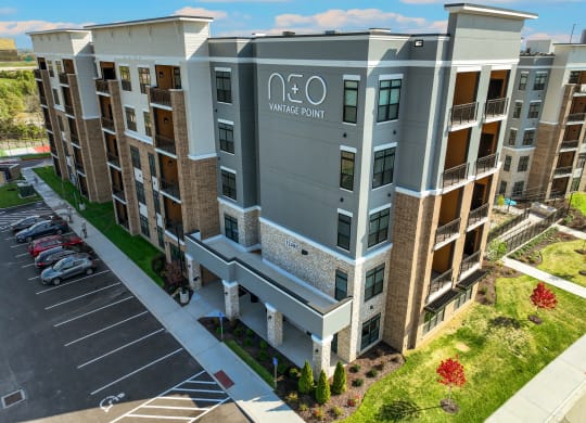 an aerial view of a large apartment building with a parking lot