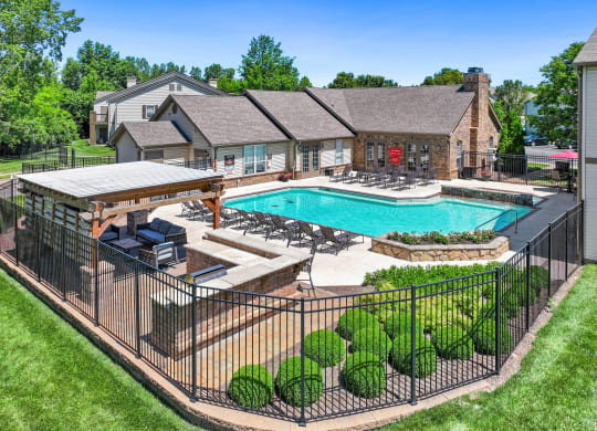 a backyard with a pool and a house with a patio