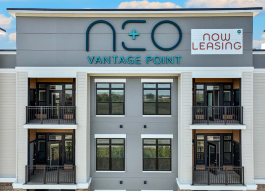 the front of a building with windows and a sign for vantage point