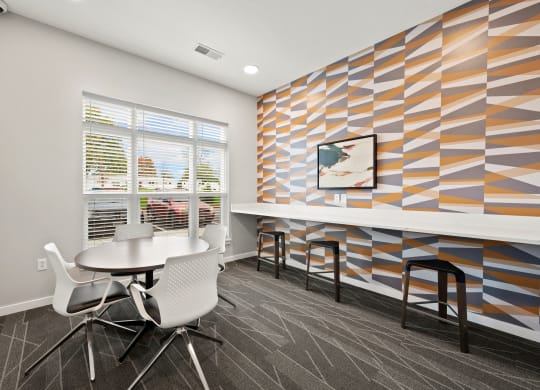 a meeting room with a table and chairs and a colorful wall