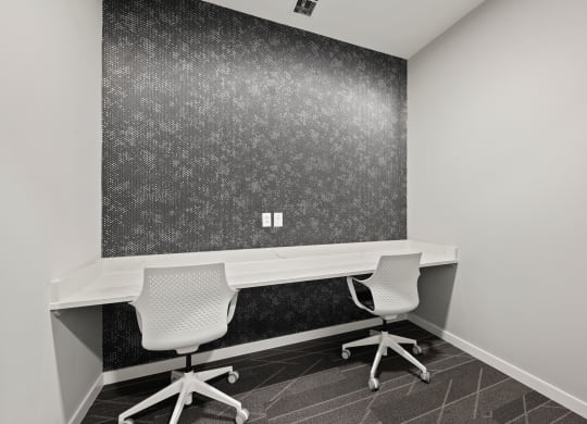 an office with two desks and two chairs