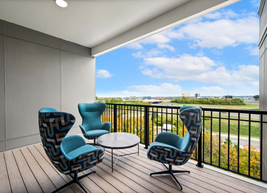 observation deck with chairs and a table and a view of a river