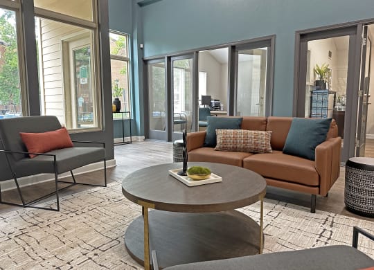 a living room with a couch and chairs and a coffee table
