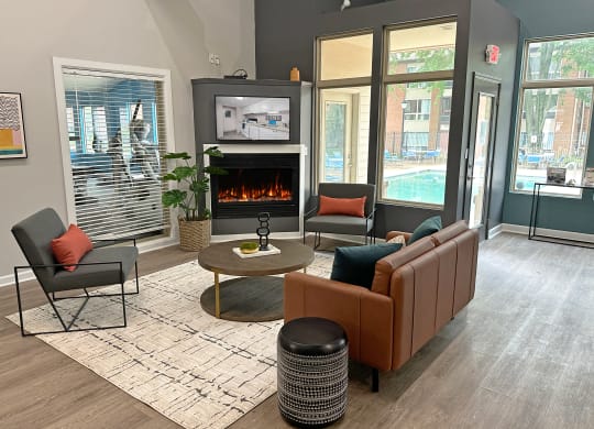 a living room with a fireplace and chairs and a table