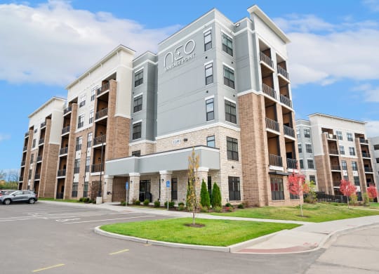 an apartment building with a car parked in front of it