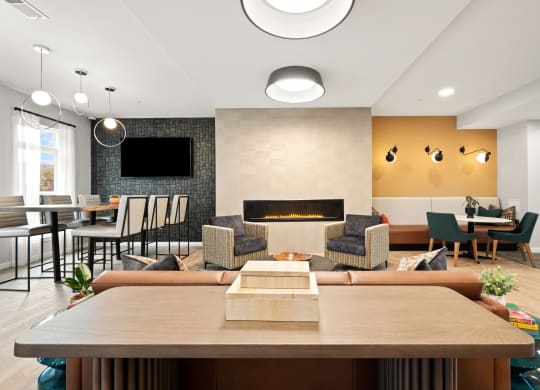 a living room with a fireplace and a table with chairs