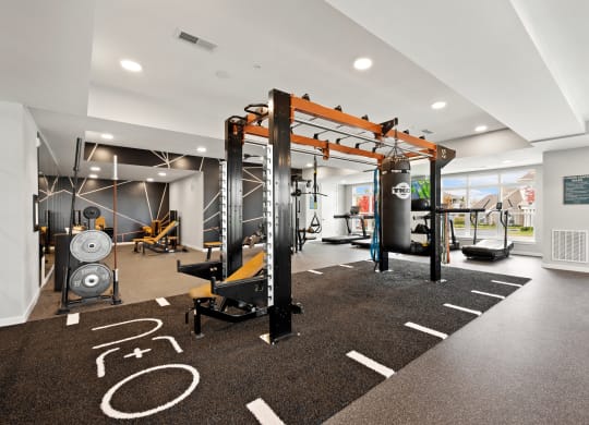 a gym with weights machines and other exercise equipment on a carpeted floor