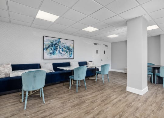 a waiting room with blue chairs and couches