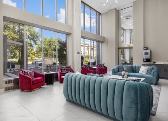 a living room filled with furniture and large windows