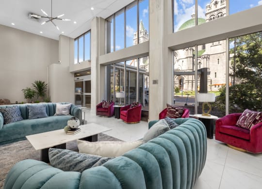 a living room filled with furniture and large windows