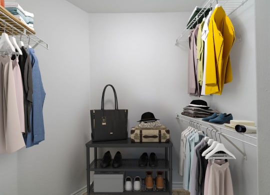 a closet with a rack of clothes and a bag