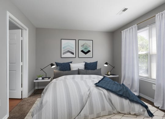 a bedroom with a bed and two windows