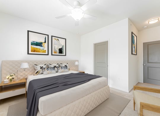 a bedroom with a large bed and a ceiling fan