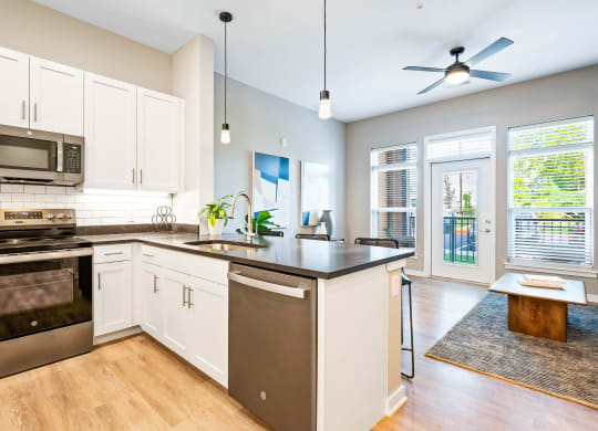 a kitchen with an island and a stove and a microwave