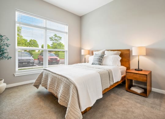 a bedroom with a large window and a bed