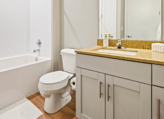 a bathroom with a toilet and a shower and a sink