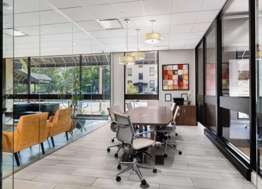 a conference room with a table and chairs in front of a window