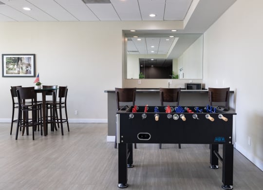 a game room with a pool table and a bar