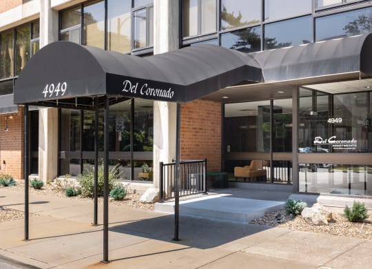 the front of a building with a black awning