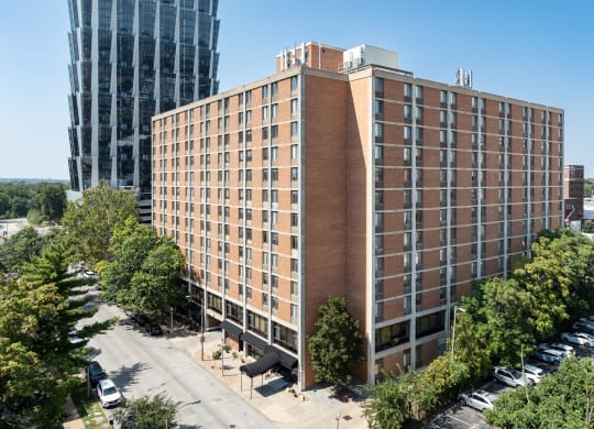 a large brick building with many windows and a parking lot