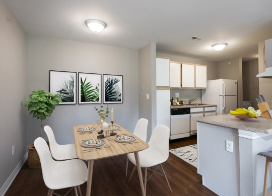 an open kitchen and dining room with a table and chairs