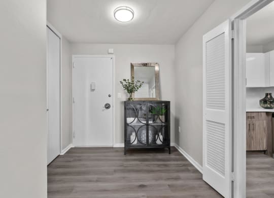 a hallway with white walls and a white door