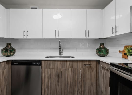 a kitchen with white countertops and wooden cabinets