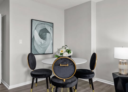 a dining room with a table and four chairs
