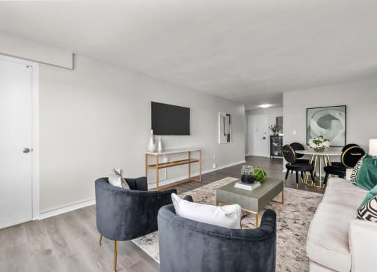 a living room with white walls and hardwood flooring