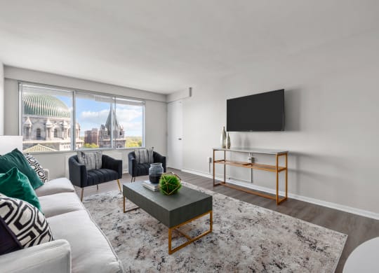 a living room with white walls and a large window