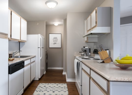 a kitchen with white appliances and counters and a white refrigerator
