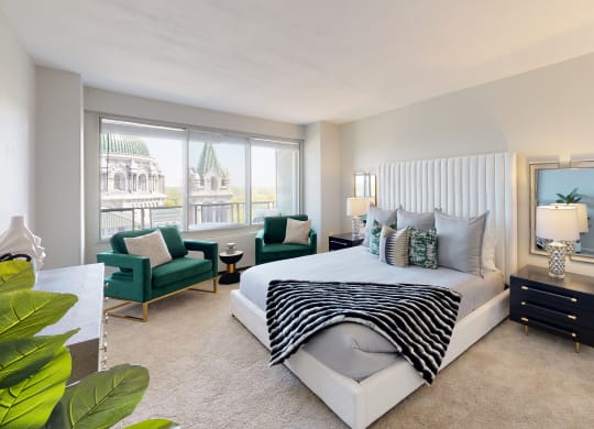 a bedroom with a bed and a chair in front of a window