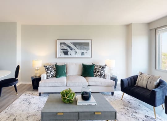 a living room with a couch coffee table and dining table
