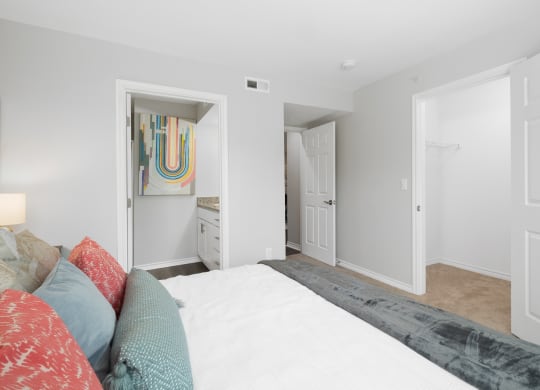 a bedroom with a large bed and a bathroom