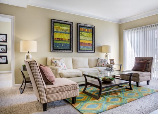 a living room with a couch and chairs and a table