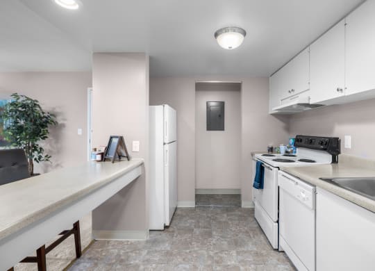 a kitchen with white appliances and counters and white cabinets