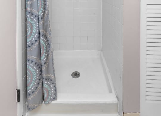 a bathroom with a shower and a curtain