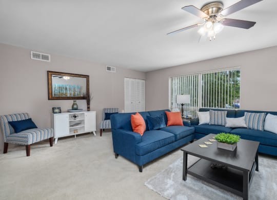 a living room with blue couches and a coffee table