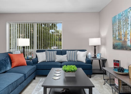 a living room with blue couches and a coffee table
