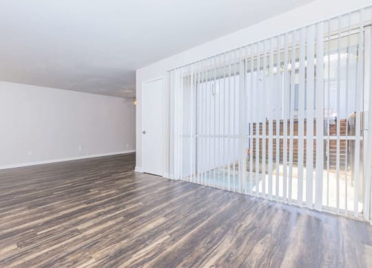 the living room of a house with wood floors and a white gate
