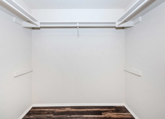 an empty room with white walls and a wood floor