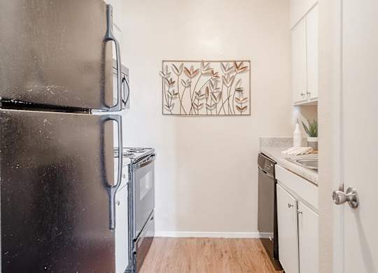 a kitchen with a refrigerator and a stove and a sink