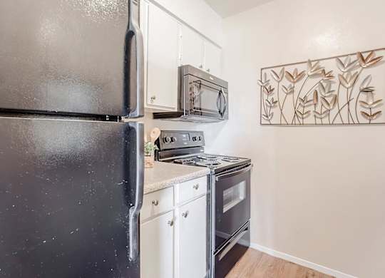 a small kitchen with a stove and a refrigerator