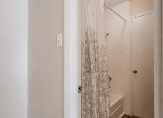 a small bathroom with a closet and a staircase