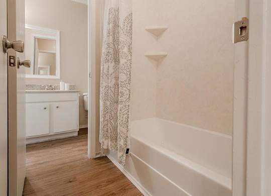a bathroom with a tub and a shower curtain