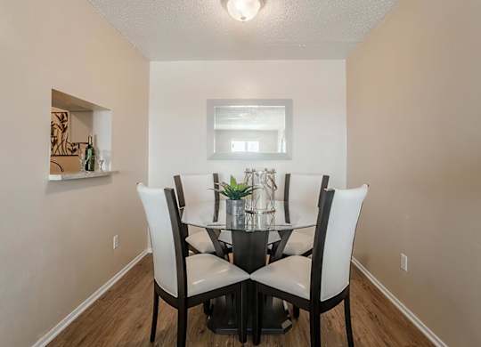 a dining room with a table and chairs