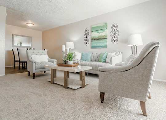 a living room with couches and chairs and a table